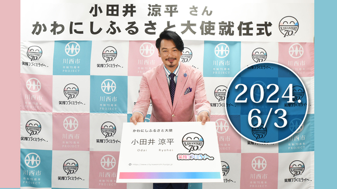 小田井涼平さん　かわにしふるさと大使就任の名刺を持って挨拶する写真